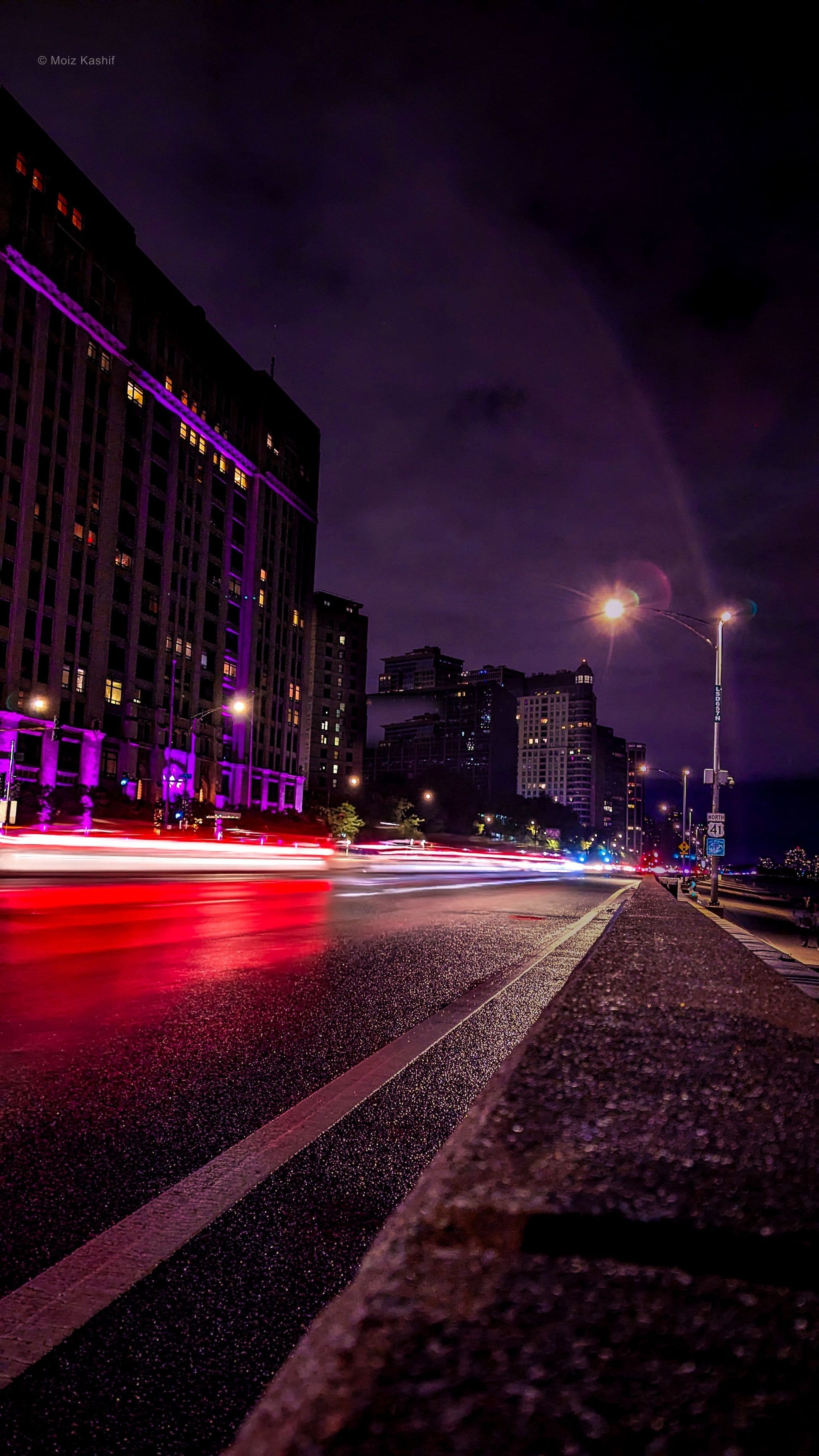 Red light trails moving along Lake Shore Drive at night.